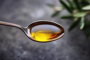 Olive oil in a spoon with greenery in the background photo