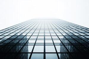 Modern skyscraper reaching into the foggy sky photo