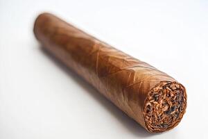 Hand-rolled cigar with natural wrapper displayed on a white surface photo