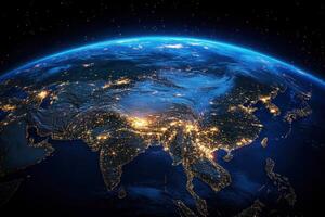 Nighttime view of Asia from space with city lights glowing photo