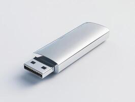 Silver USB flash drive resting on a light background photo