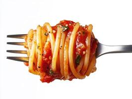 Spaghetti twirled on a fork with tomato sauce and herbs photo