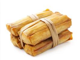 Delicious tamales wrapped in corn husks ready for serving photo