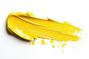 Yellow paint splattered on white during creative work photo