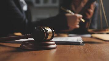 Lawyer and judge on a desk with a gavel and scales of justice video