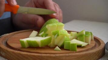 Man is Dicing and Cutting Apples with Knife on Cutting Board. Close-Up Shot video