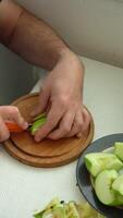 Man is Dicing and Cutting Apples with Knife on Cutting Board. Vertical video