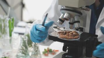 A person in a lab coat is looking at nuts video