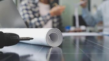 A man is working on a solar panel with a roll of paper video