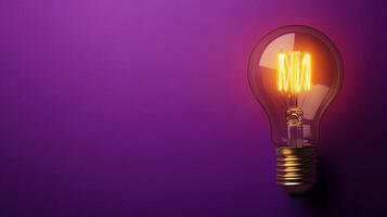 A light bulb on a purple background photo