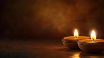 Two burning candles on a wooden table photo