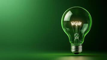 Green light bulb on a green background photo