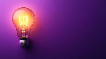 A light bulb on a purple background photo