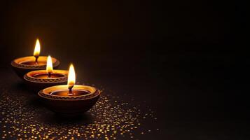 Three Diwali lit diyas on a black background photo