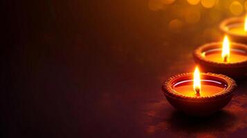 Three lit candles on a dark background Diwali photo