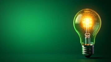 A glowing light bulb on a green background photo