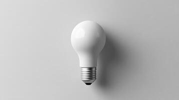 A white light bulb on a gray background photo