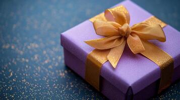 A purple gift box with a gold ribbon photo