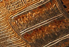 A close up of a metal object with some lines photo