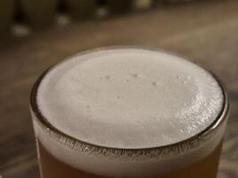 Chilled Beer in Drinkware with Foam on Tableware wallpaper photo