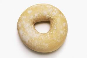 A doughnut is shown on a white surface photo