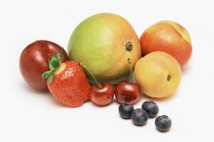 A group of fruits including strawberries, blueberries, and peaches photo