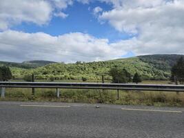 A view of a highway with a sign that says stop photo