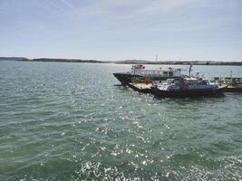 A boat is docked at a dock in the water photo