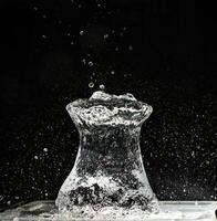 A vase with water splashing out of it photo