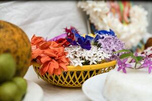 A basket of flowers and a plate of rice photo