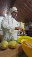 Assistant Chef In Uniform Peels Potatoes Before A Service In An Italian Kitchen video