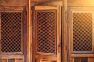 open wooden door with lattice to confessional for confession inside the Catholic Cathedral close-up photo