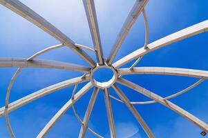 Metal construction of art object on background of blue sky background. Amphitheater in Navruz Park in Tashkent, Uzbekistan photo