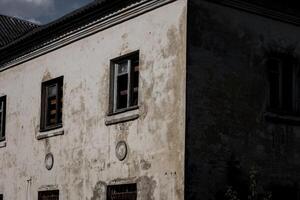 abandoned building with broken windows photo
