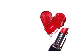 Smearing red heart-shaped lipstick with lipstick banner on a white background. Red lipstick glossy texture in heart shape. Cosmetic product swatch copy space photo
