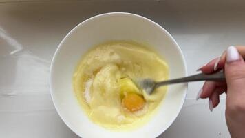 Mixing eggs with a hand mixer, close-up. Cooking in the home kitchen. Beating chicken eggs with a hand mixer Mixing Eggs in a Bowl for Cake Batter video