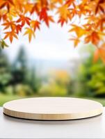 Empty wooden table with autumn leaves on the background photo
