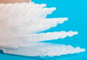 Tubes with medicine on a blue background. Concept of a laxative for the treatment of constipation in the intestines. Restoration of intestinal microflora, close-up photo