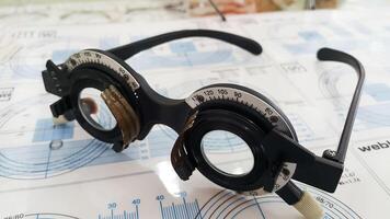 Phoropter eyeglasses on display in an optometry office during an eye exam session photo