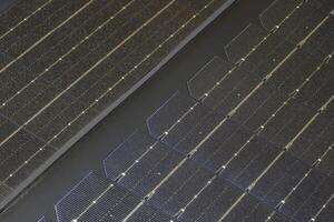 Close up of solarcell texture showing grid patterns and reflective surfaces during daylight photo