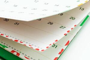 Closeup view of calendar pages showing days and dates for planning activities and events photo