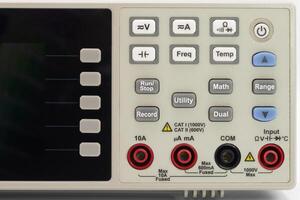 Front panel view of a digital multimeter displaying various function options and input jacks photo