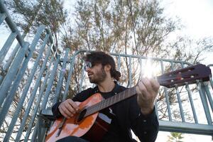 Man Plays Music With Classical Guitar Inexpensive Instrument photo