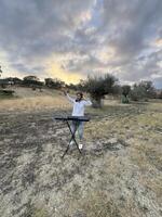 Boy Plays Keyboard In Nature In Calabria Countryside photo