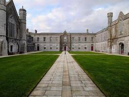 Amazing University of Galway, quadrangle in Ireland, historical architecture and landmarks background photo