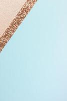 Minimalist abstract design with gold glitter and pastel blue background. photo