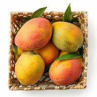 Ripe mangos in a woven basket with vibrant colors and fresh leaves. photo