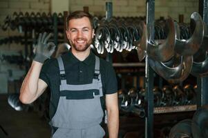 Portrait,, of man in uniform that is in workstation developing details of agriculture technique photo