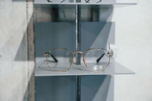 Close up view of glasses that is on the shelves indoors in the store.. photo