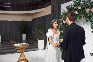 Watching at each other. Beautiful bride with his fiance is on the wedding photo